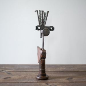 Mr. Hatchet, a handcrafted industrial metal hatchet sculpture made from reclaimed tools, standing upright on a tabletop.