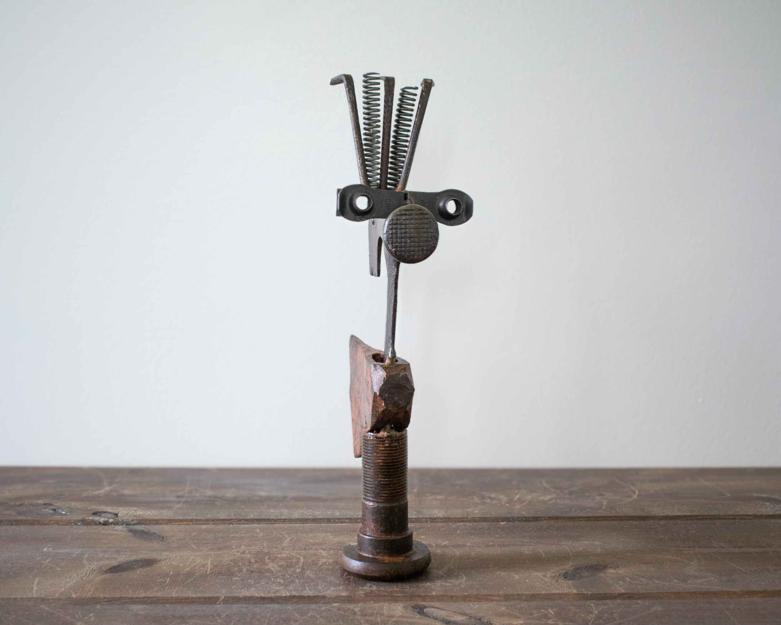 Mr. Hatchet, a handcrafted industrial metal hatchet sculpture made from reclaimed tools, standing upright on a tabletop.