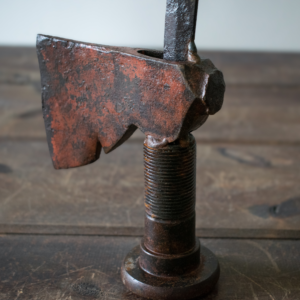 Close-up of Mr. Hatchet hatchet head and threaded bolt base showing raw metal finish and natural patina.