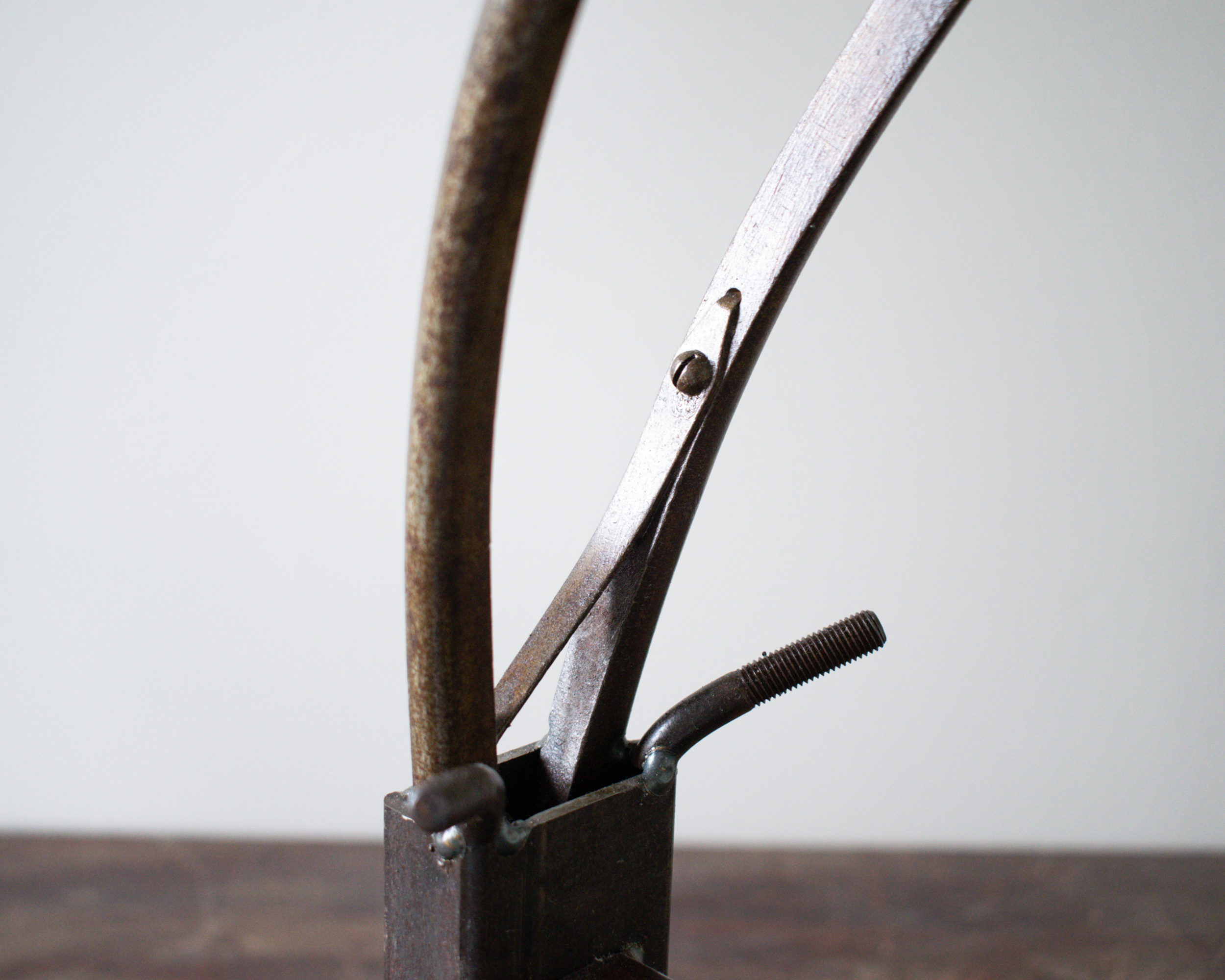 Close-up of welded metal antelope head with pliers forming the horns.