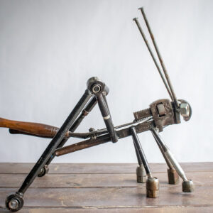 Side view of metal insect sculpture made from reclaimed tools and heavy-duty steel parts.