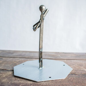 Angled view of a small metal baseball player sculpture on a steel tabletop base.