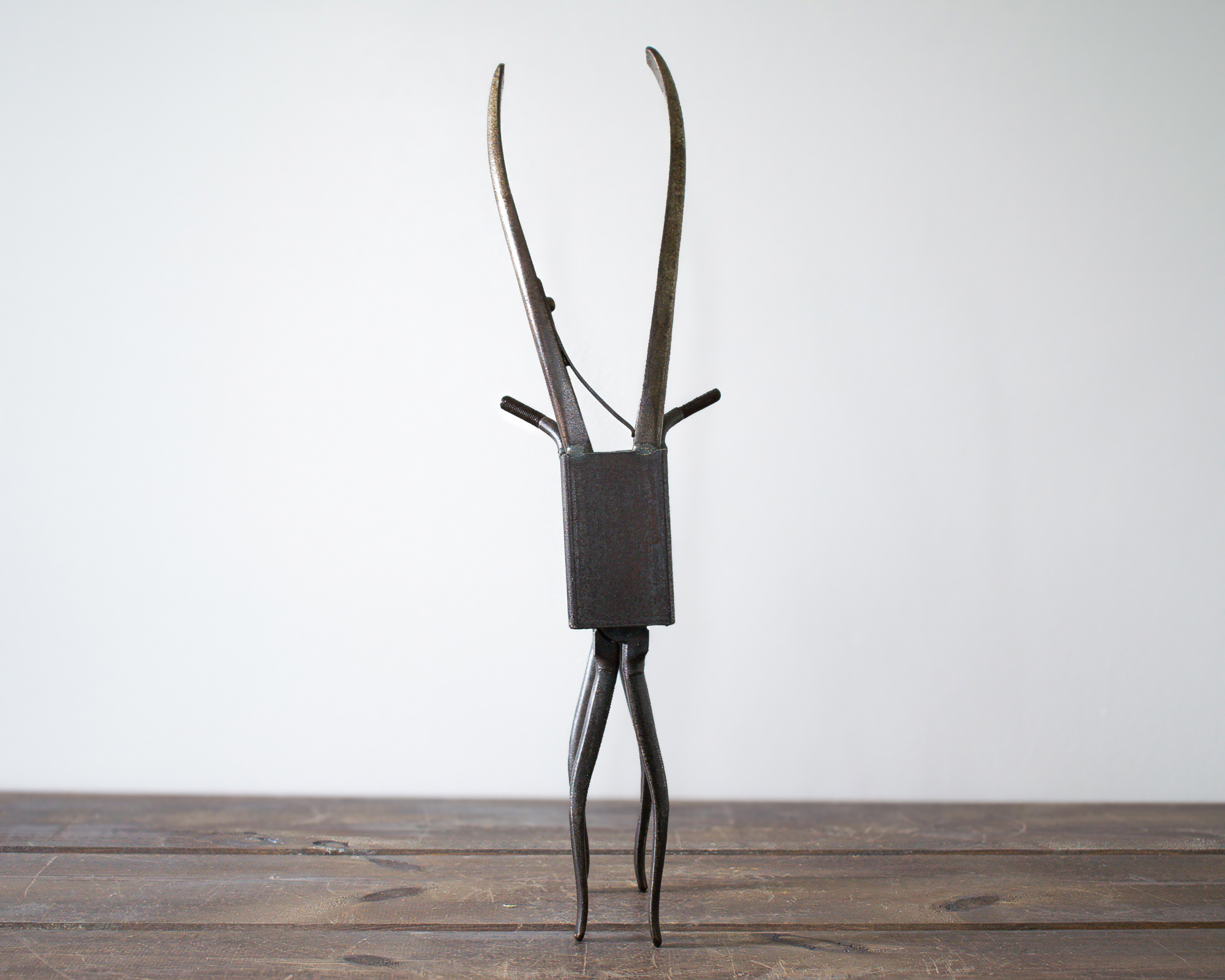 Welded metal antelope sculpture made from reclaimed steel, curved pliers, and rectangular tubing.