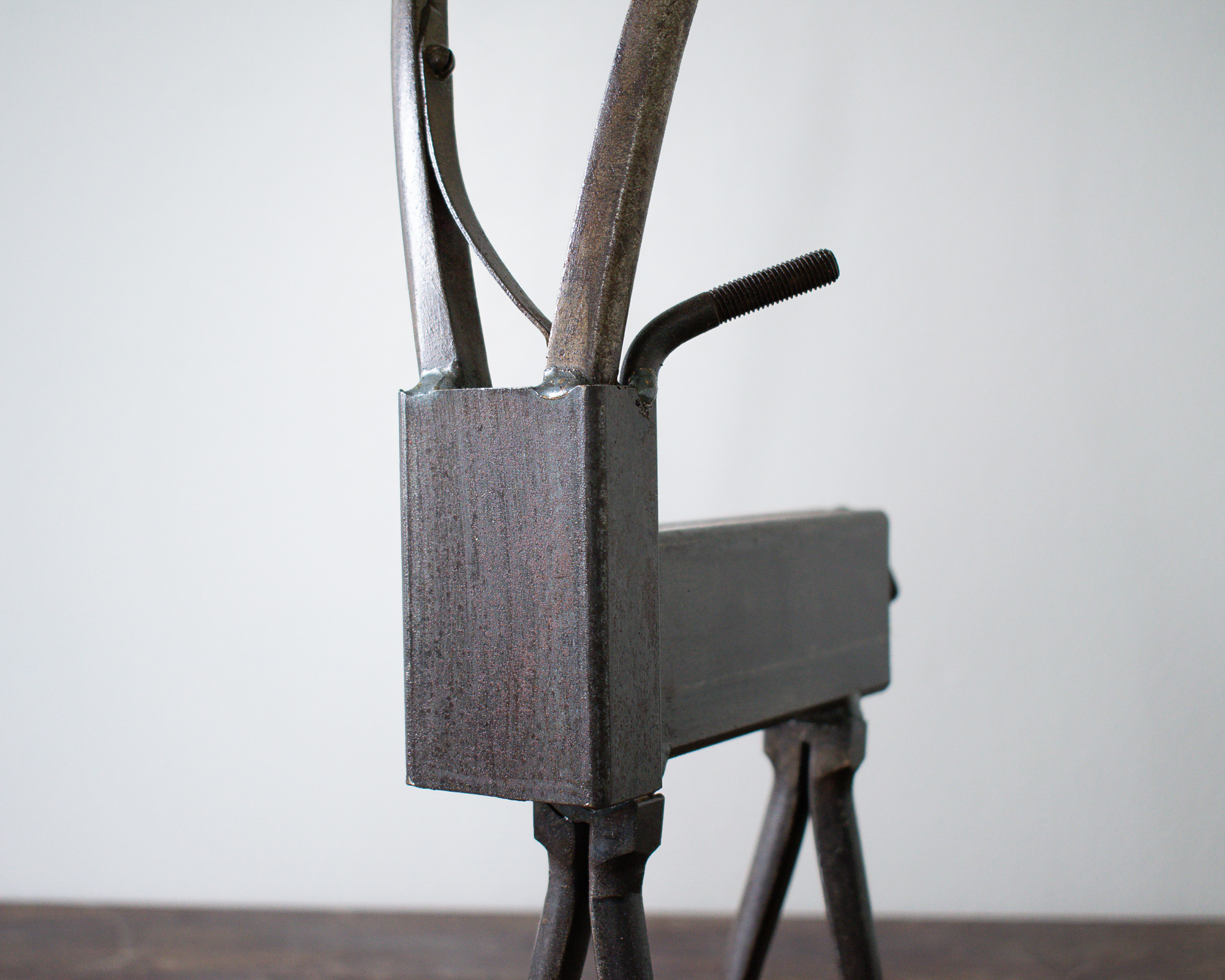 Close-up of the antelope head and curved plier horns on a reclaimed welded metal antelope sculpture.