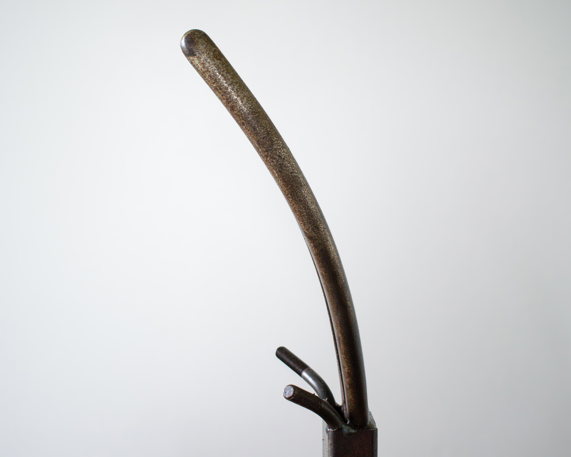 Detailed view of the curved plier horn used in a welded metal antelope sculpture.