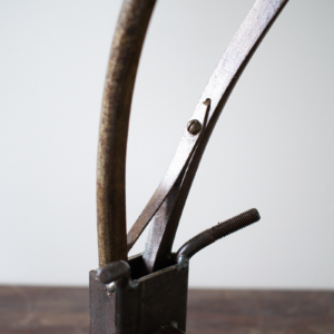 Close-up rear view of reclaimed steel horns and welded hardware on industrial animal art sculpture.