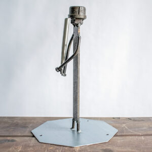 Side view of baseball metal art showing a handmade scrap metal figure holding a bat.