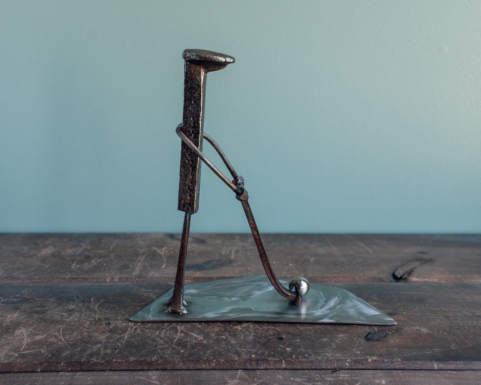 Side view of industrial golf decor made from reclaimed steel and old shop materials.