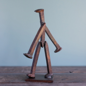 Side view of The Wandering Spike, a handmade metal sculpture made from reclaimed railroad spikes.