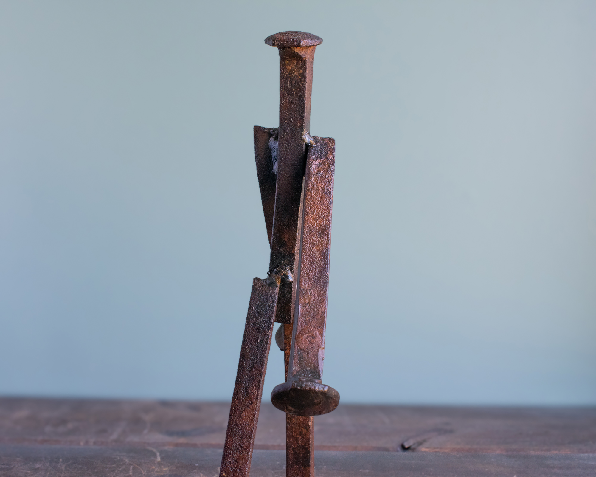 Close-up of textured reclaimed railroad spikes and weld details on The Wandering Spike sculpture.