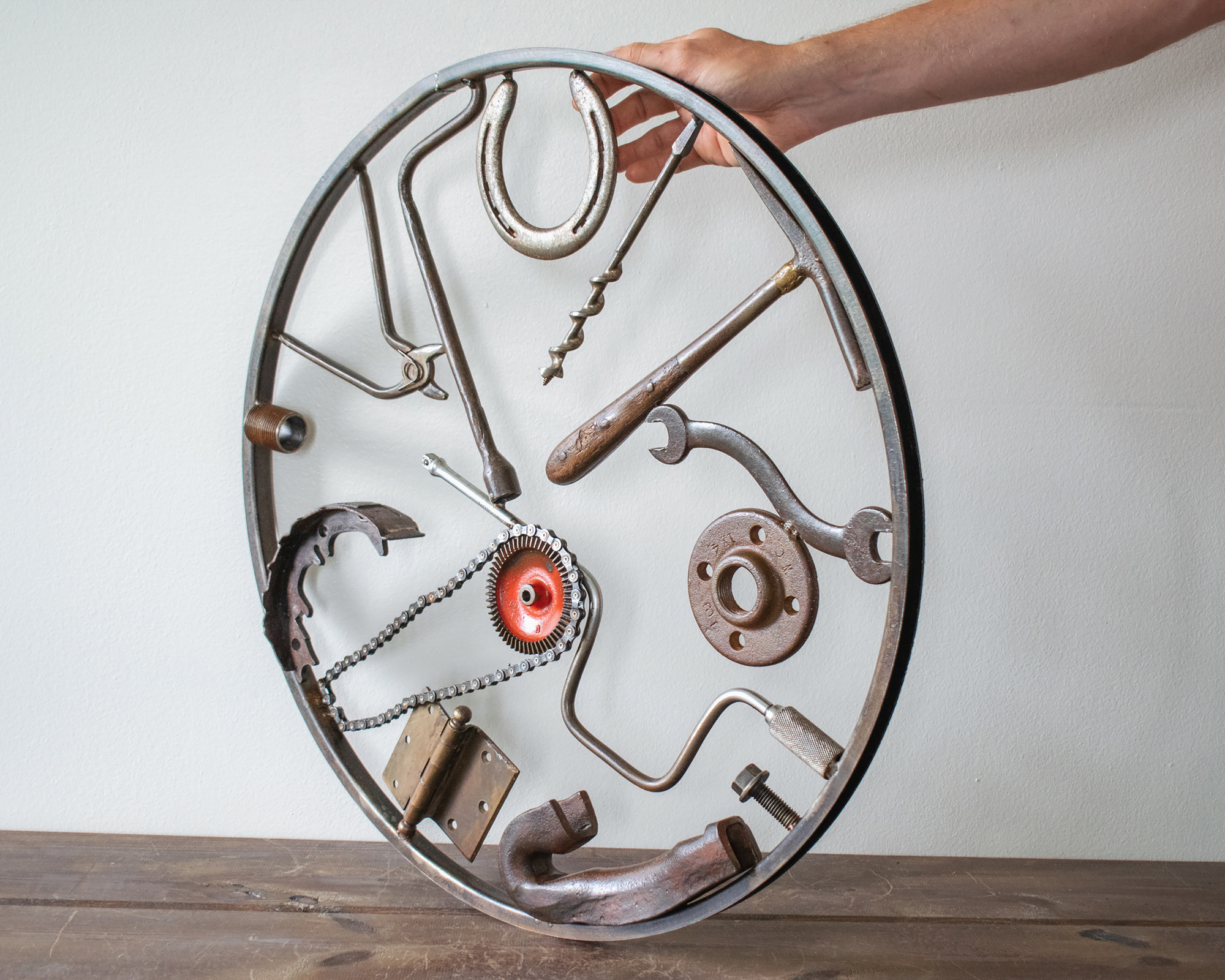 Angled view of music-inspired welded tool sculpture made from reclaimed metal parts and old hand tools.