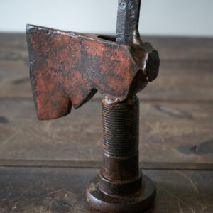 Close-up of the axe head and large bolt base on a welded metal hatchet sculpture made from reclaimed steel.